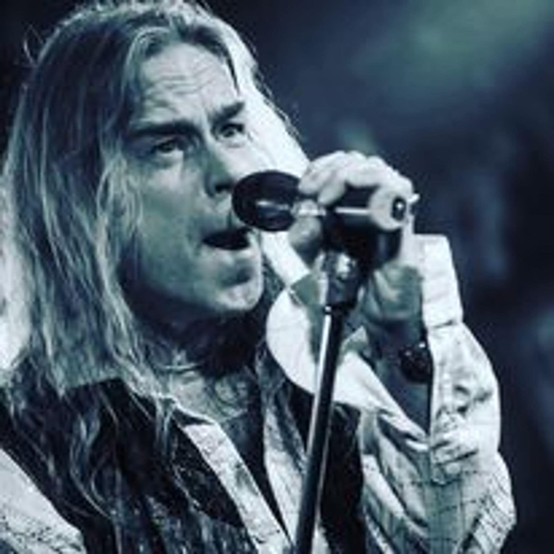 Close-up of Brian Bee Frank singing into the microphone