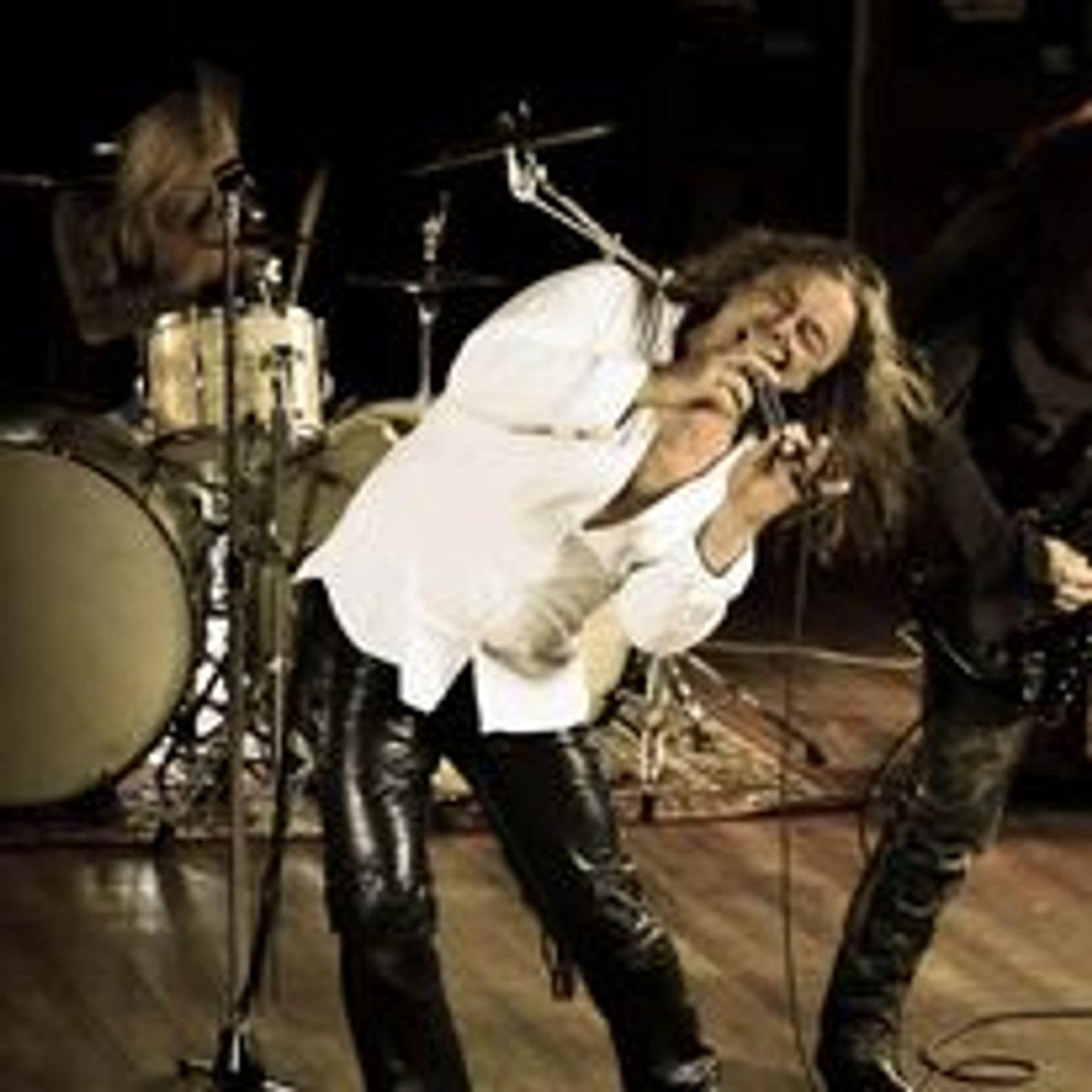 Brian Bee Frank live with the full band, leaning into the microphone